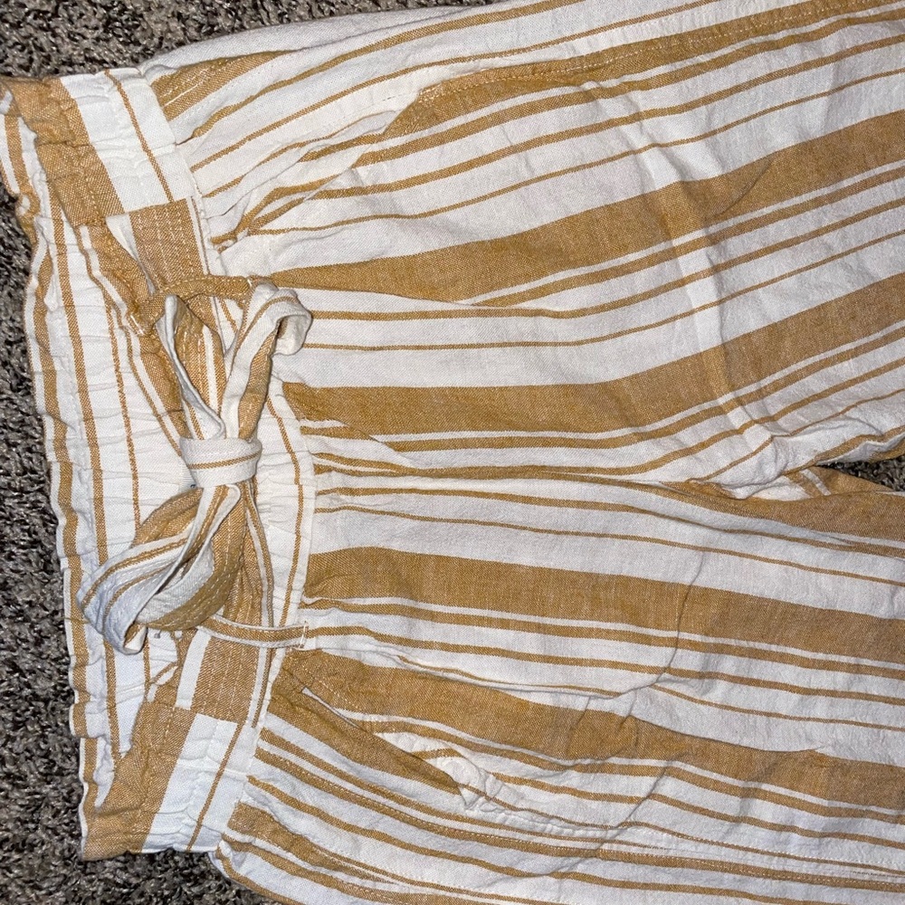 Small gold and white striped Rewind stretch pants with attached belt.